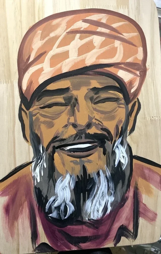 Khaled Nabhan, Martyrs & Heroes, Portrait by Caleb Wassell: a smiling elderly Palestinian man with a white beard and patterned head wrap.