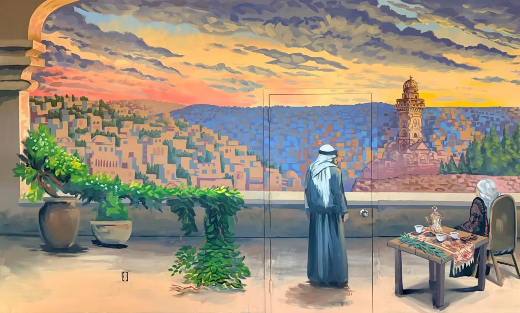 Rooftop over Jerusalem, The Minaret, mural by Caleb Wassell: a man in a keffiyeh looks out from an arched rooftop terrace over the hills and a minaret of Jerusalem at sunset, with potted plants and a coffee table.